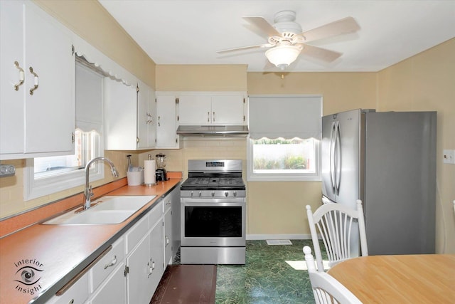 7117 W 82nd Pl, Burbank, IL 60459 - kitchen with stainless steel appliances, under cabinet range hood, backsplash, white cabinets, and light countertops