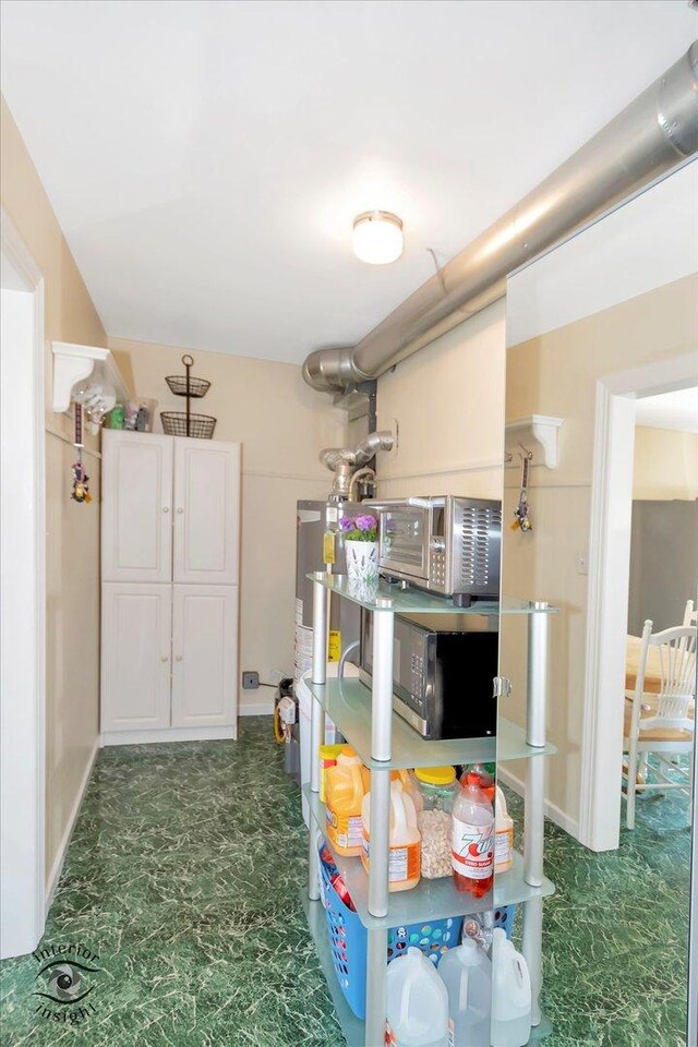 7117 W 82nd Pl, Burbank, IL 60459 - kitchen with water heater and white cabinets