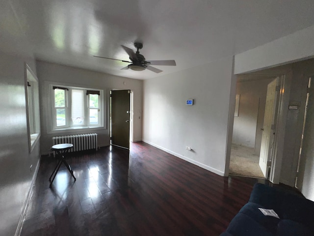 10007 S Hoxie Ave, Chicago, IL 60617 - unfurnished living room with radiator, a ceiling fan, and wood finished floors