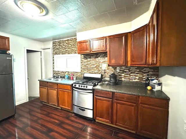10007 S Hoxie Ave, Chicago, IL 60617 - kitchen featuring appliances with stainless steel finishes, decorative backsplash, dark wood-type flooring, and dark countertops