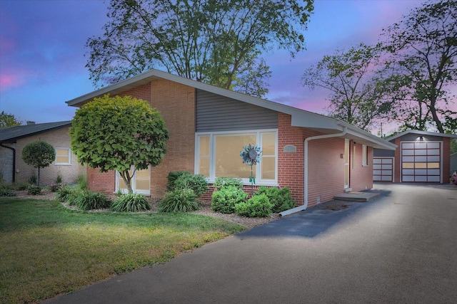 17436 71st Ave, Tinley Park, IL 60477 - property exterior at dusk with brick siding, an outbuilding, a lawn, and a garage