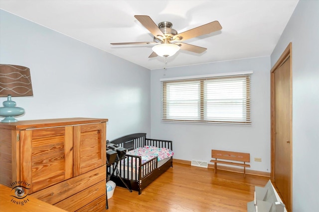 17436 71st Ave, Tinley Park, IL 60477 - bedroom featuring light wood-type flooring, a closet, ceiling fan, and a crib