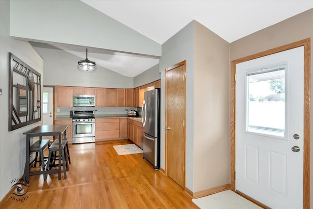 17436 71st Ave, Tinley Park, IL 60477 - kitchen featuring stainless steel appliances, vaulted ceiling, light wood-type flooring, light countertops, and decorative light fixtures