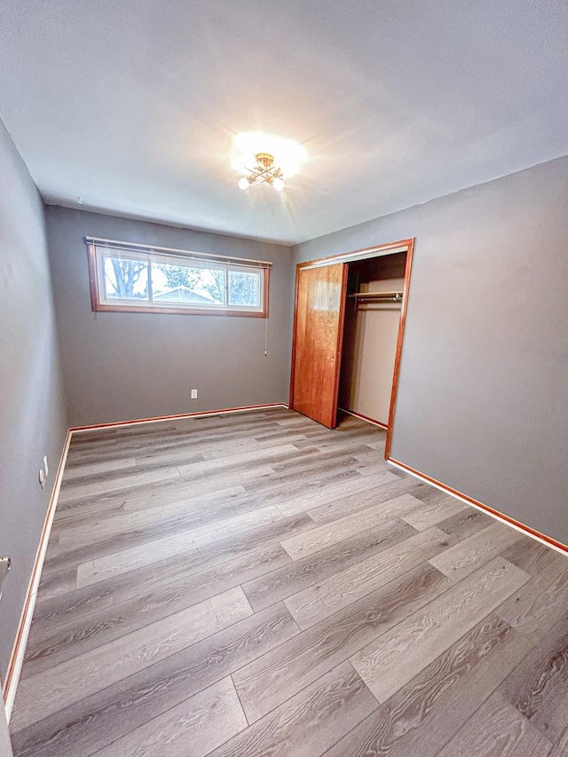 425 W Donald St, Kankakee, IL 60901 - unfurnished bedroom featuring wood finished floors and a closet