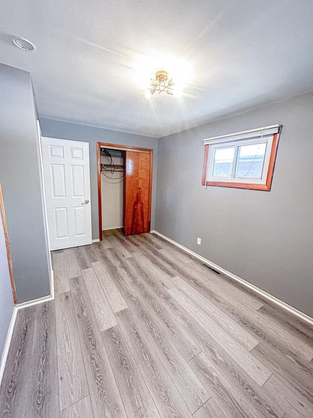 425 W Donald St, Kankakee, IL 60901 - unfurnished bedroom featuring wood finished floors and a closet