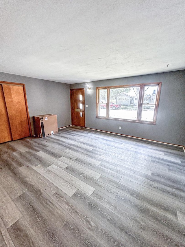 425 W Donald St, Kankakee, IL 60901 - unfurnished living room featuring wood finished floors and a textured ceiling