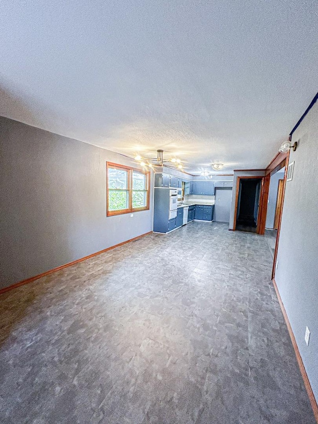 425 W Donald St, Kankakee, IL 60901 - unfurnished living room featuring a textured ceiling and a textured wall