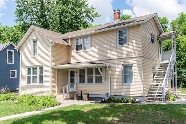 637/639 E Wilson St, Batavia, IL 60510 - traditional-style home featuring stairs, a chimney, and a front lawn