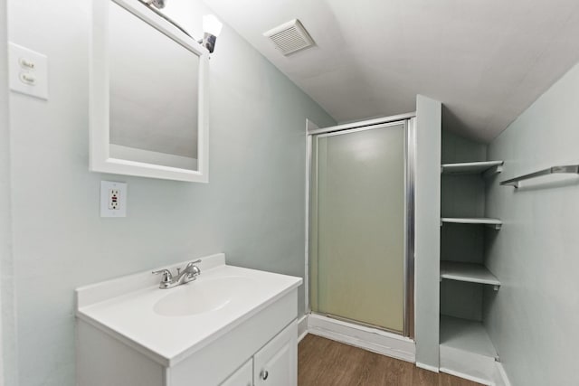 637/639 E Wilson St, Batavia, IL 60510 - full bathroom with vanity, a stall shower, wood finished floors, and vaulted ceiling