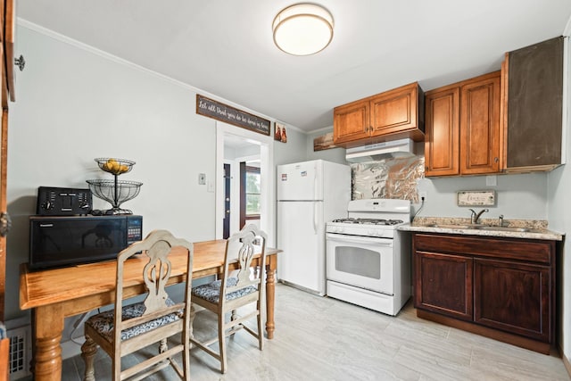 637/639 E Wilson St, Batavia, IL 60510 - kitchen featuring white appliances, under cabinet range hood, ornamental molding, light countertops, and brown cabinets