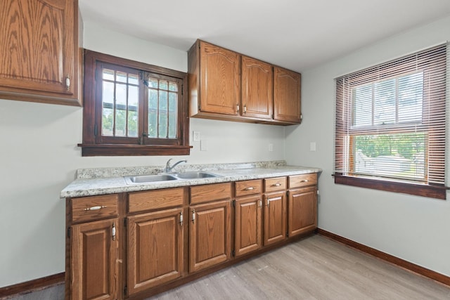 637/639 E Wilson St, Batavia, IL 60510 - kitchen featuring brown cabinets, light wood-style floors, and light countertops