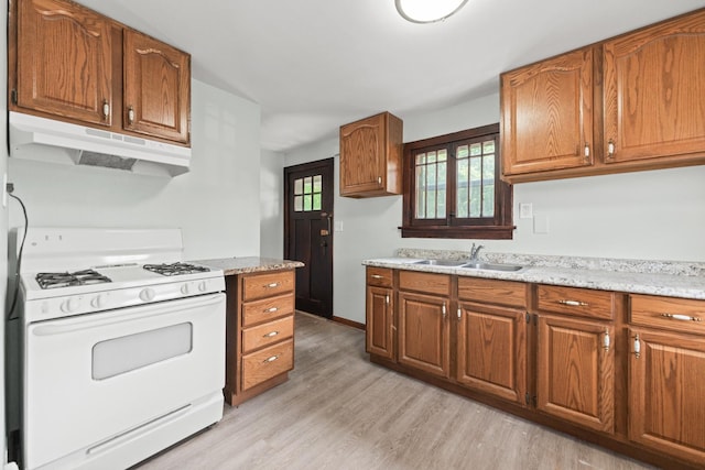 637/639 E Wilson St, Batavia, IL 60510 - kitchen featuring white range with gas cooktop, under cabinet range hood, and brown cabinets