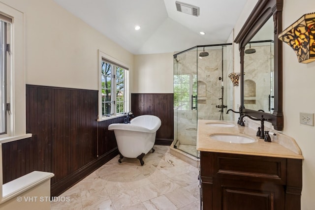 733 N Kensington Ave, La Grange Park, IL 60526 - bathroom featuring a wainscoted wall, lofted ceiling, marble finish floors, a freestanding bath, and a stall shower