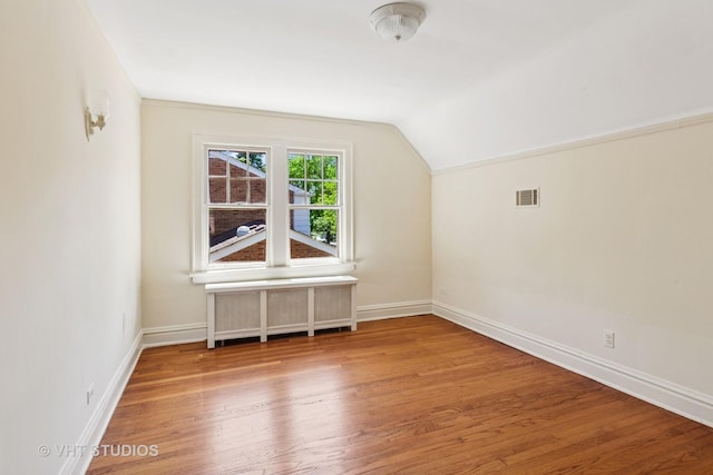 733 N Kensington Ave, La Grange Park, IL 60526 - bonus room featuring radiator heating unit, wood finished floors, and vaulted ceiling