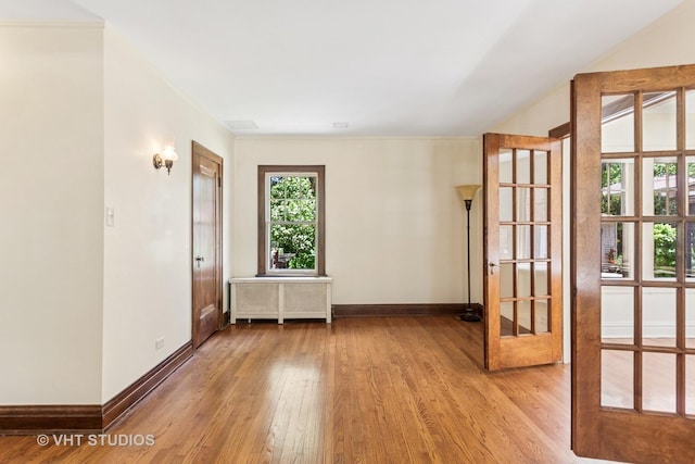 733 N Kensington Ave, La Grange Park, IL 60526 - unfurnished room featuring light wood-style floors, french doors, and radiator heating unit