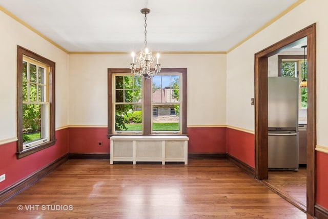 733 N Kensington Ave, La Grange Park, IL 60526 - unfurnished dining area featuring wood finished floors, a chandelier, and radiator
