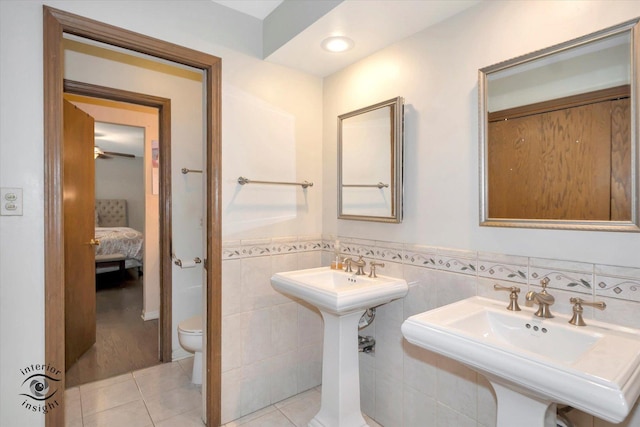 19126 Pierce Ave, Homewood, IL 60430 - bathroom featuring tile patterned flooring, connected bathroom, a wainscoted wall, and tile walls