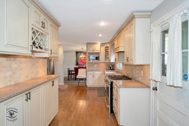 19126 Pierce Ave, Homewood, IL 60430 - kitchen featuring stainless steel appliances, decorative backsplash, light wood-style flooring, glass insert cabinets, and recessed lighting
