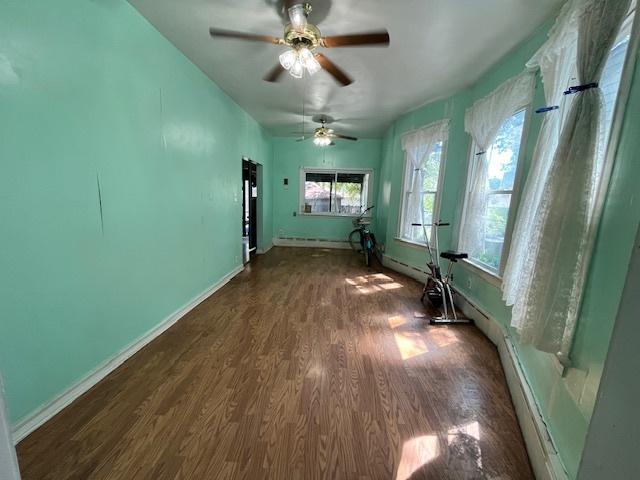 3651 W 64th Pl, Chicago, IL 60629 - spare room with dark wood-style flooring and ceiling fan