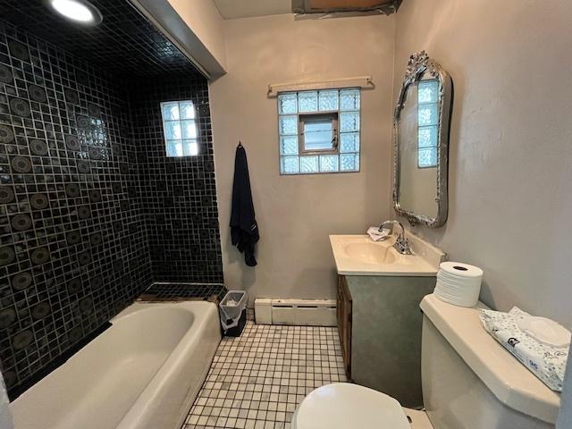 3651 W 64th Pl, Chicago, IL 60629 - bathroom with a baseboard radiator, vanity, shower / washtub combination, and tile patterned flooring