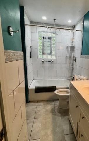 3651 W 64th Pl, Chicago, IL 60629 - bathroom featuring tile walls, vanity, bathtub / shower combination, and tile patterned flooring