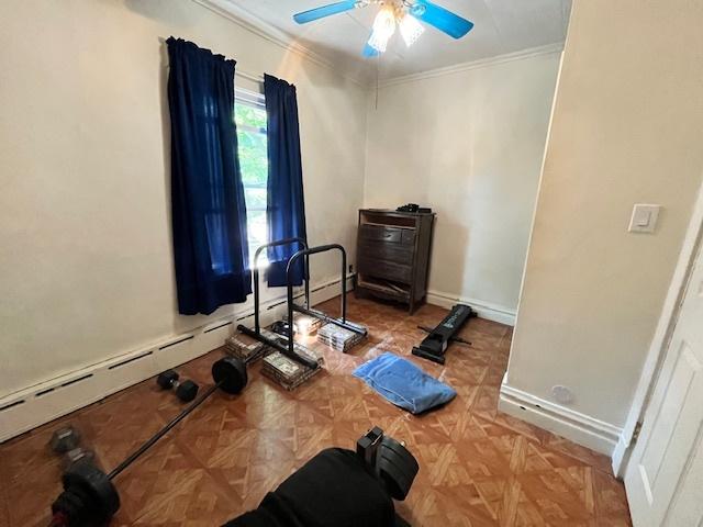 3651 W 64th Pl, Chicago, IL 60629 - exercise room with ornamental molding, a ceiling fan, and a baseboard radiator