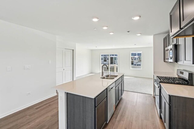6339 Ulster Dr, Tinley Park, IL 60477 - kitchen with appliances with stainless steel finishes, wood finished floors, a center island with sink, light countertops, and recessed lighting