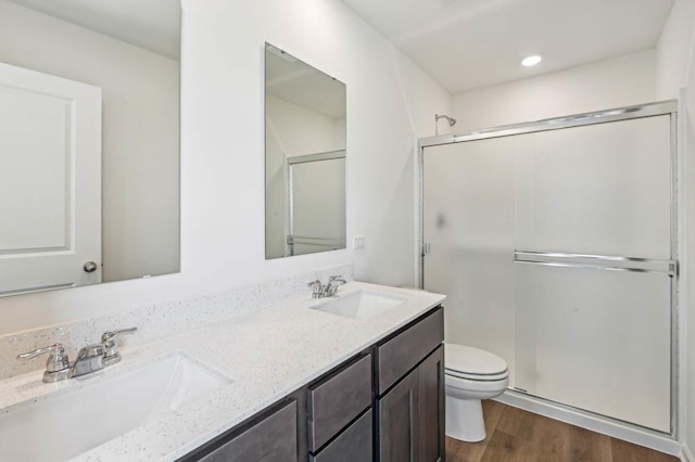 6339 Ulster Dr, Tinley Park, IL 60477 - bathroom featuring a shower stall, double vanity, wood finished floors, and recessed lighting