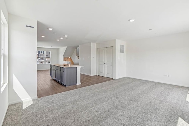 6339 Ulster Dr, Tinley Park, IL 60477 - kitchen featuring dark carpet, recessed lighting, open floor plan, an island with sink, and light countertops