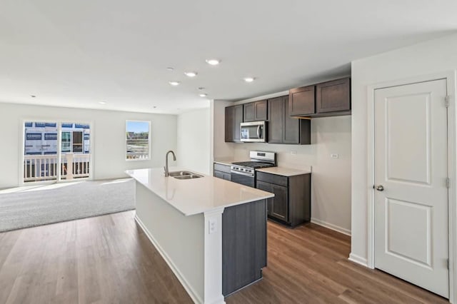 6339 Ulster Dr, Tinley Park, IL 60477 - kitchen with appliances with stainless steel finishes, dark wood-type flooring, dark brown cabinets, an island with sink, and recessed lighting