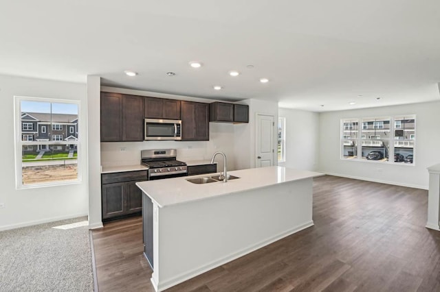 6339 Ulster Dr, Tinley Park, IL 60477 - kitchen with appliances with stainless steel finishes, dark brown cabinets, plenty of natural light, an island with sink, and recessed lighting