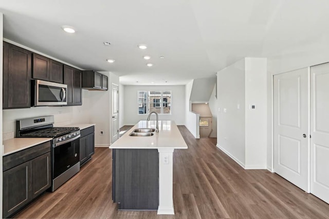 6339 Ulster Dr, Tinley Park, IL 60477 - kitchen featuring stainless steel appliances, light countertops, wood finished floors, dark brown cabinetry, and an island with sink