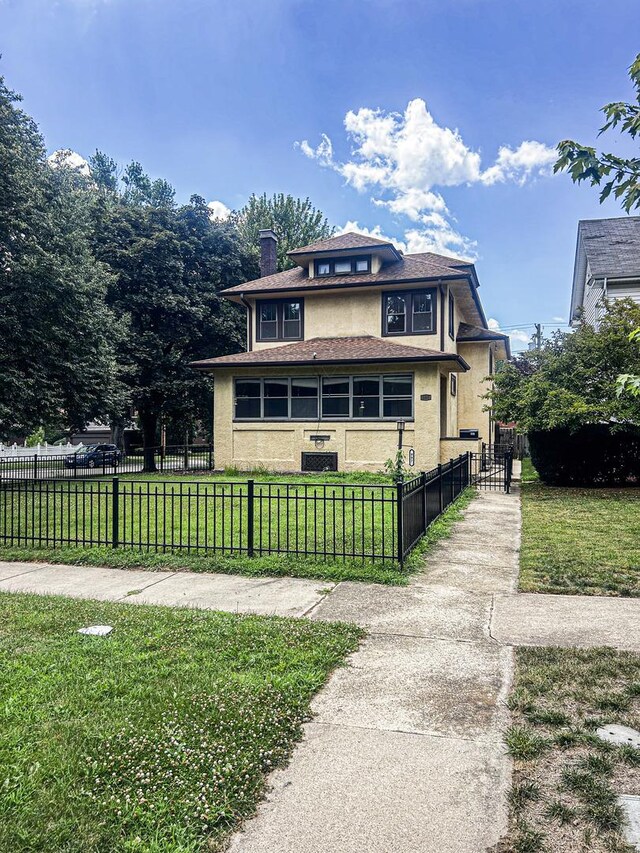 997 S Evergreen Ave, Kankakee, IL 60901 - view of front facade featuring a chimney, a fenced front yard, and stucco siding