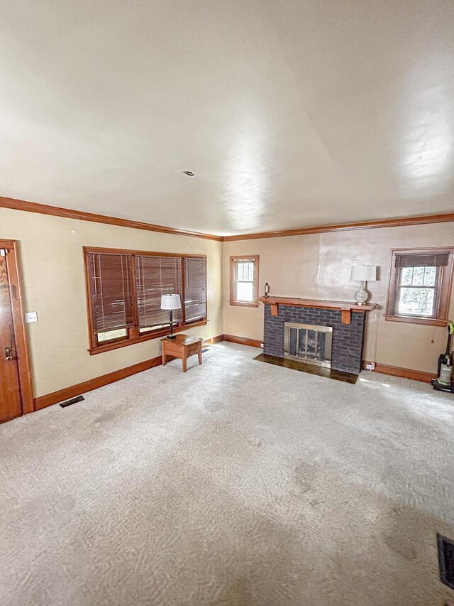 997 S Evergreen Ave, Kankakee, IL 60901 - unfurnished living room with ornamental molding, a fireplace with flush hearth, and carpet