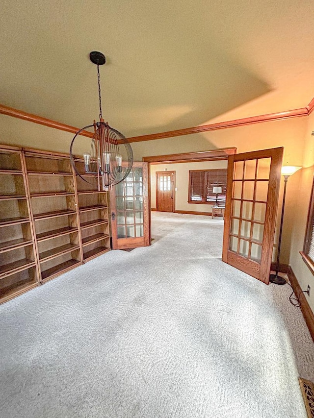 997 S Evergreen Ave, Kankakee, IL 60901 - carpeted empty room with a chandelier and crown molding