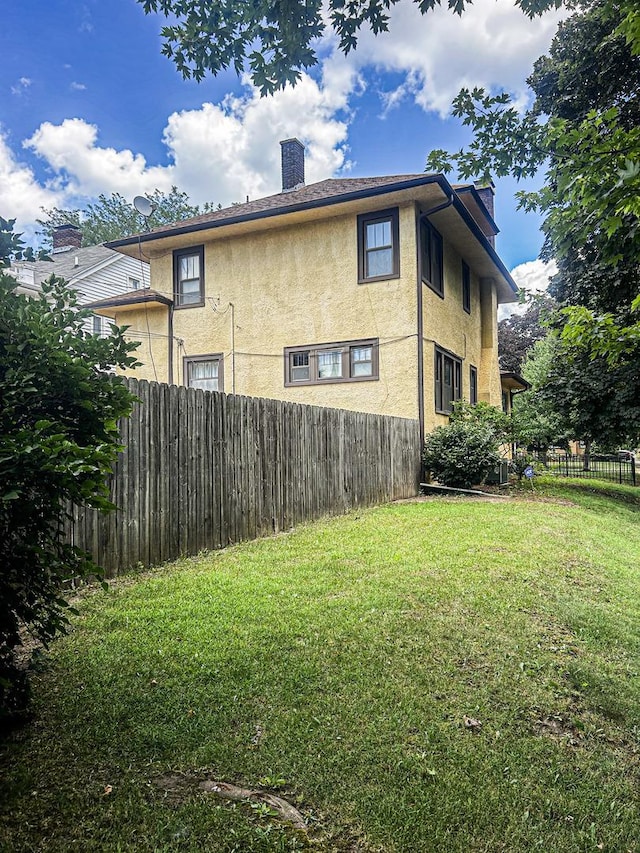 997 S Evergreen Ave, Kankakee, IL 60901 - view of property exterior featuring stucco siding and a chimney