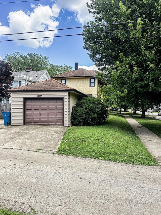 997 S Evergreen Ave, Kankakee, IL 60901 - view of front of property featuring a garage, driveway, stucco siding, and a shingled roof