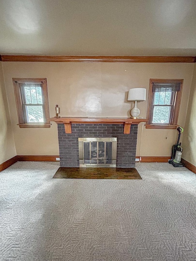 997 S Evergreen Ave, Kankakee, IL 60901 - unfurnished living room with carpet floors, a fireplace, and crown molding