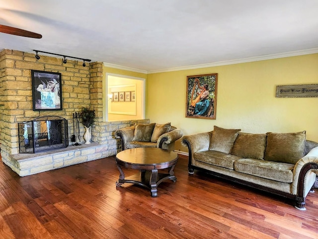 20798 White Oaks Rd, Morrison, IL 61270 - living room with rail lighting, wood finished floors, crown molding, a fireplace, and ceiling fan