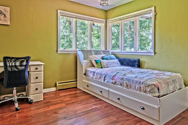 20798 White Oaks Rd, Morrison, IL 61270 - bedroom with a baseboard radiator, multiple windows, and wood finished floors