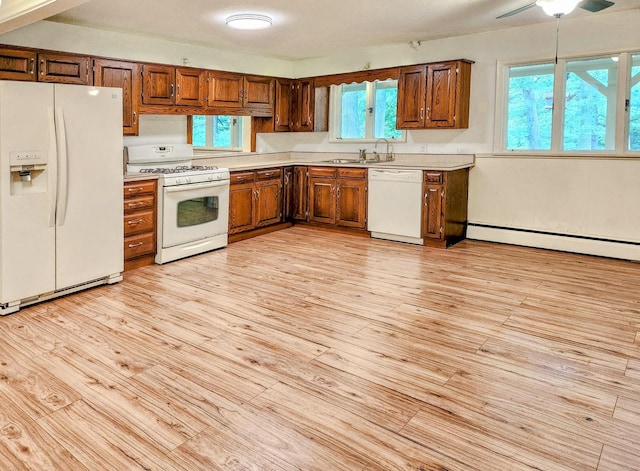 20798 White Oaks Rd, Morrison, IL 61270 - kitchen featuring white appliances, light countertops, baseboard heating, light wood-style floors, and brown cabinetry