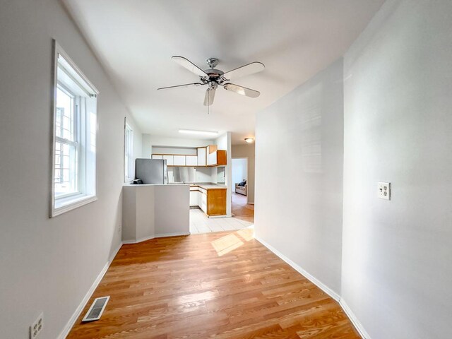 2458 N Clybourn Ave, Chicago, IL 60614 - unfurnished living room with light wood-type flooring and a ceiling fan