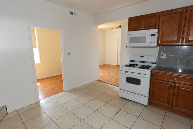 2458 N Clybourn Ave, Chicago, IL 60614 - kitchen with white appliances, tasteful backsplash, and light tile patterned floors