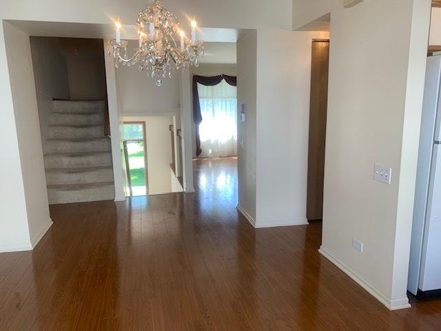 2235 Dawson Ln, Algonquin, IL 60102 - interior space with wood finished floors, a chandelier, and stairway