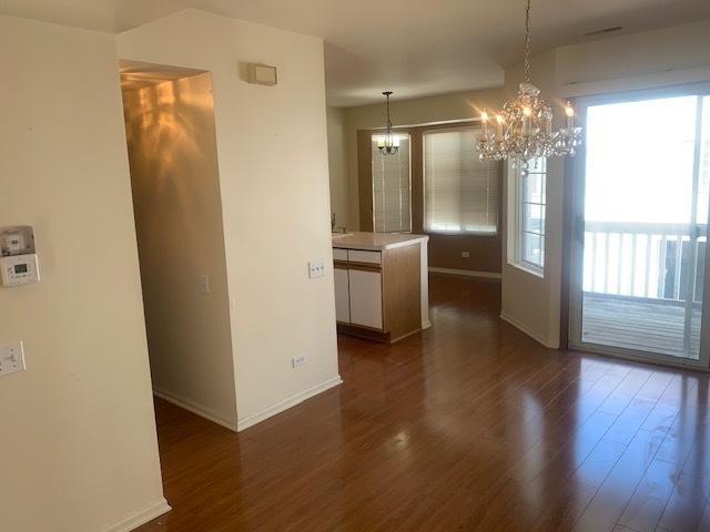 2235 Dawson Ln, Algonquin, IL 60102 - unfurnished dining area with a chandelier, dark wood finished floors, and plenty of natural light