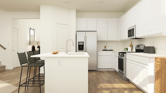 607 Wexford Dr, Elgin, IL 60124 - kitchen with appliances with stainless steel finishes, light wood-type flooring, white cabinets, a center island with sink, and light countertops