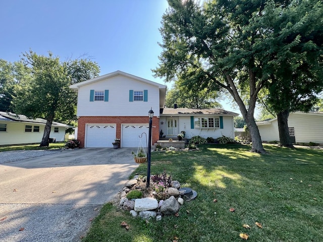 17 Park Dr, Villa Grove, IL 61956 - split level home with concrete driveway, a garage, a front lawn, and brick siding