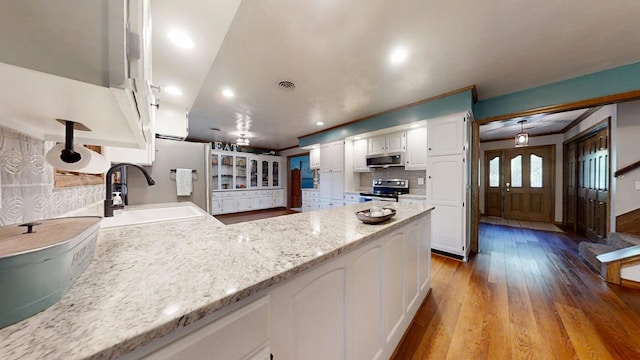 17 Park Dr, Villa Grove, IL 61956 - kitchen featuring stainless steel appliances, white cabinets, light wood-type flooring, a peninsula, and recessed lighting