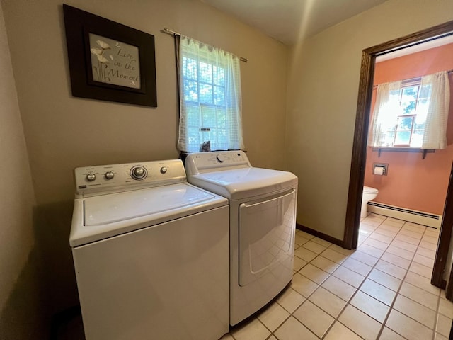 17 Park Dr, Villa Grove, IL 61956 - laundry area featuring washing machine and dryer, a baseboard heating unit, plenty of natural light, and light tile patterned floors