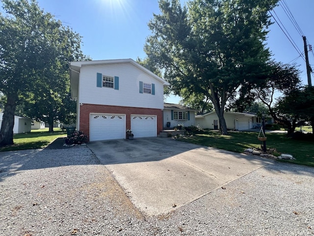17 Park Dr, Villa Grove, IL 61956 - view of front of house with driveway, a garage, brick siding, and a front yard